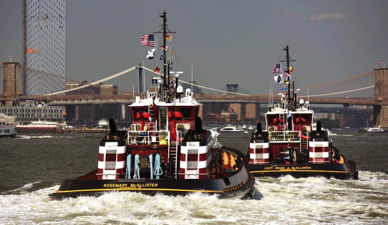 The Rosemary and Captain Brian McAllister sailing towards the Brooklyn Bridge in NY Harbor.