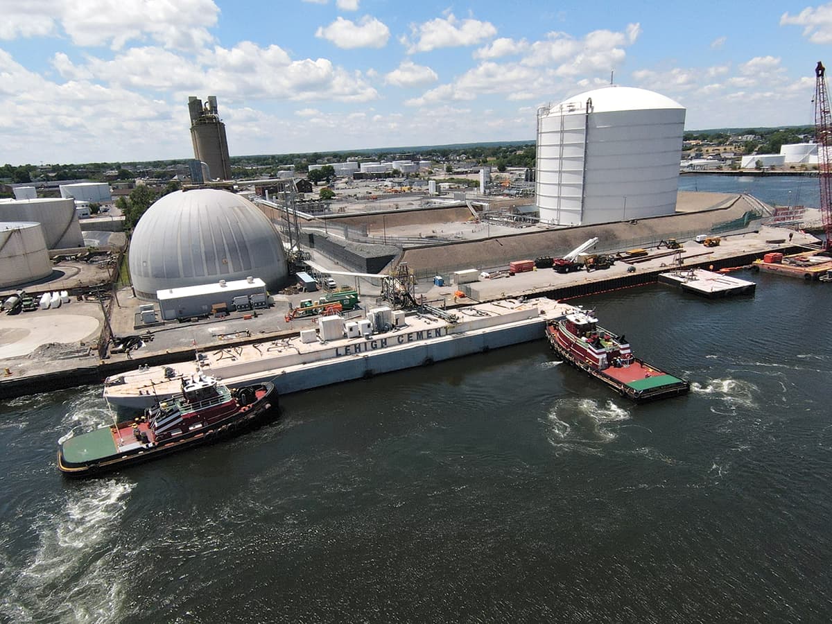 The tugs Patrick McAllister and Rainbow work on a cement barge in Providence, Rhode Island.