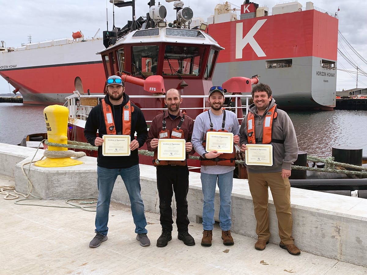 The crew of the Buckley McAllister is presented with Certificates of Appreciation.