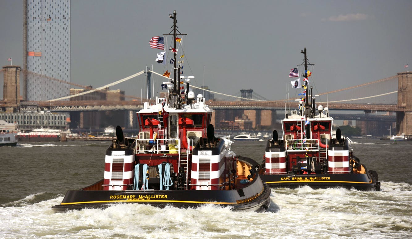 The Rosemary and Captain Brian McAllister sailing towards the Brooklyn Bridge in NY Harbor.