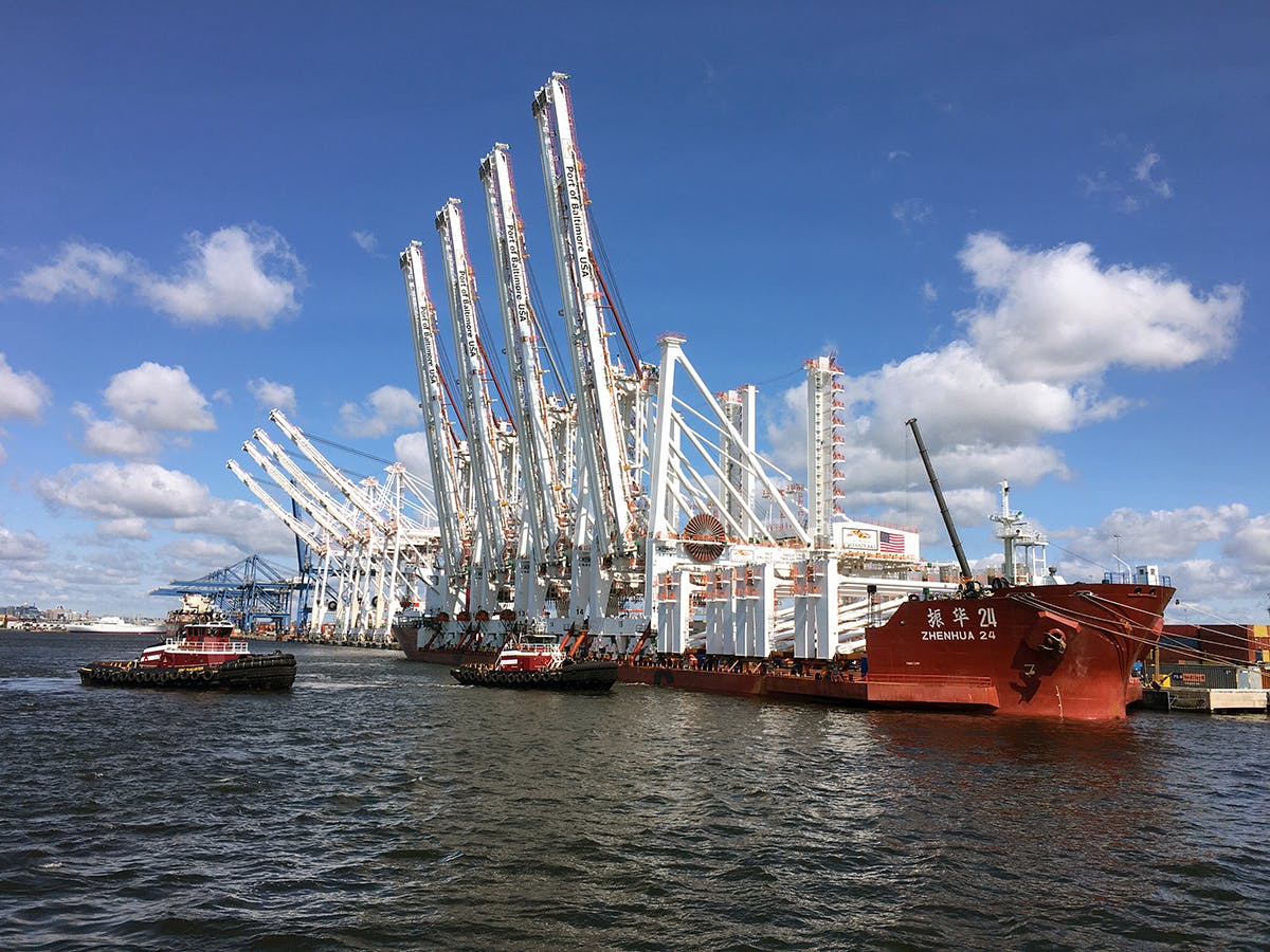 The tugs Bridget and Eric McAllister welcome new container cranes into the Port of Baltimore.